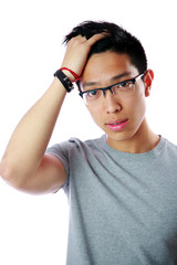 Portrait of a young serious asian man over white background