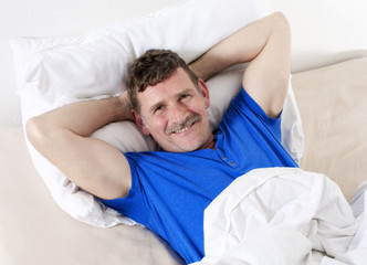 man in bed smiling
