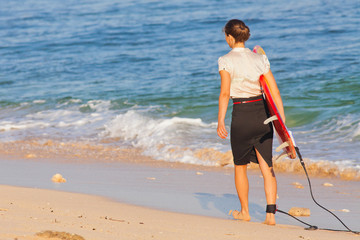 Businesswoman with surf near the ocean