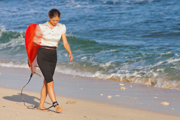Businesswoman with surf near the ocean