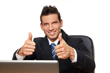 Handsome man in suit at computer shows you thumbs up