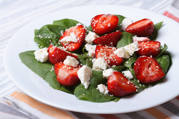 Fresh strawberry salad with spinach and cheese