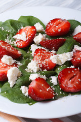 salad with strawberries, spinach, goat cheese and sesame