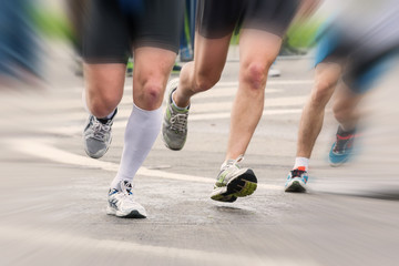 Fototapeta premium detail of the legs of runners at the start of a marathon race
