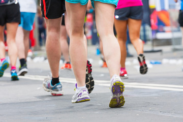 detail of the legs of runners at the start of a marathon race
