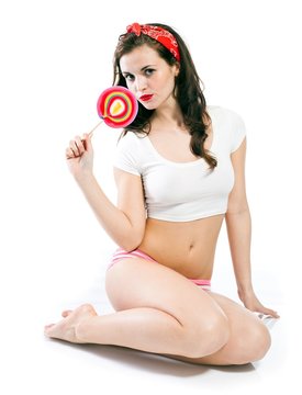 Pretty pinup girl in panties with big lollipop