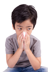 kid cleaning nose with tissue isolated on white