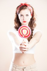 Pin up girl with big lollipop