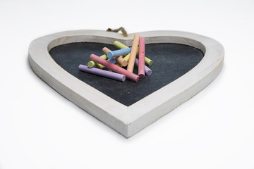 Isolated heart shaped blackboard with colored chalk