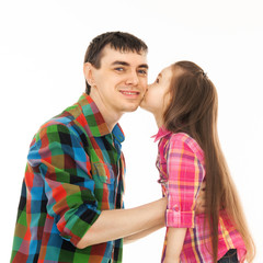Portrait of little girl kissing her father.