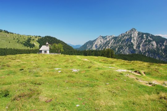 View of meadow with a church in Postalm, Austrian Alps