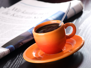 cup of coffee and the newspaper on the table