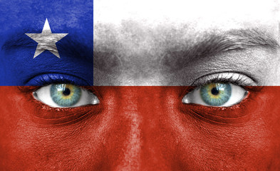 Human face painted with flag of Chile