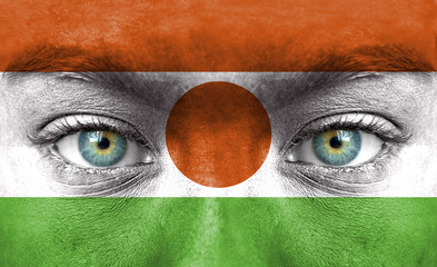 Human face painted with flag of Niger