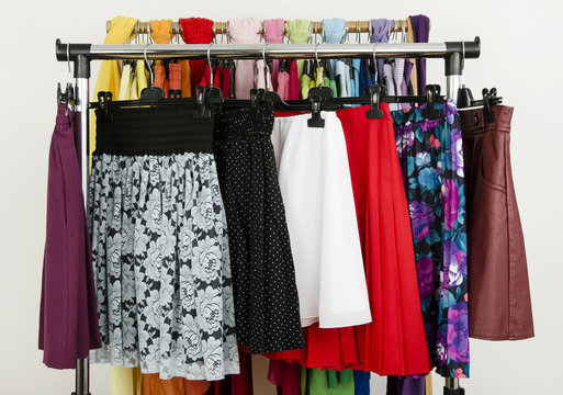 Wardrobe with colorful summer skirts displayed on a rack.
