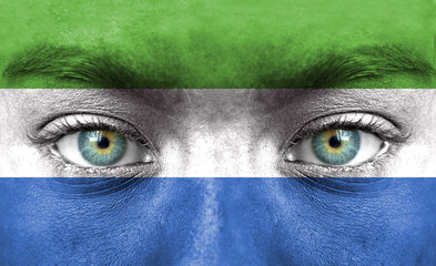 Human face painted with flag of Sierra Leone