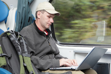 Tourist with laptop in the train