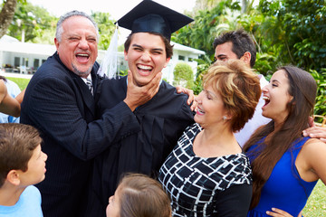 Hispanic Student And Family Celebrating Graduation