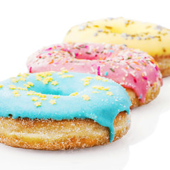 Three glazed donuts isolated on white background