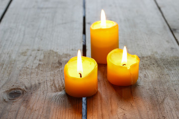 Beautiful golden candles on wooden table