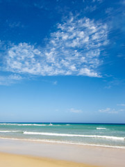 Fototapeta na wymiar tropical beach with clouds creating a heart shape in the sky