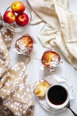 Breakfast table with cakes, coffee and fruits