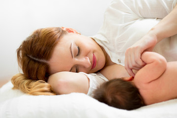 Obraz na płótnie Canvas happy mother breast feeding her newborn baby
