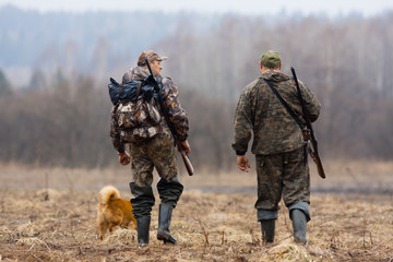 two hunters and dog