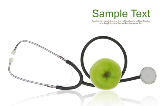 Stethoscope with green apple isolated on white
