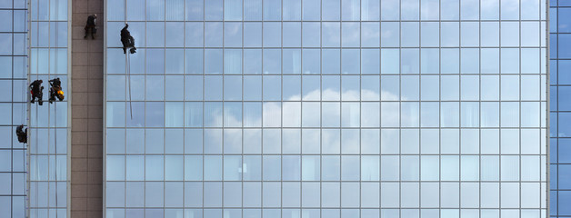 Men cleaning windows on a corporate bouilding