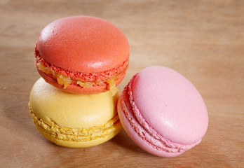 French macarons on a wooden background.