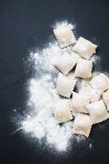 Square italian cheese ravioli with dough, above view, copyspace