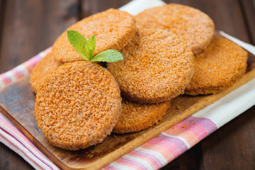 Raw fish cutlets on a rustic wooden cutting board, studio shot