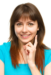 Fototapeta premium Young woman is supporting her head with hand