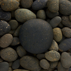 big circle stone on small pebbles, group of rocks in round shape