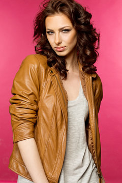 Beautiful young brunette in the leather jacket