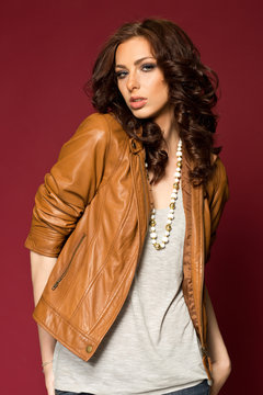 Beautiful young brunette in the leather jacket
