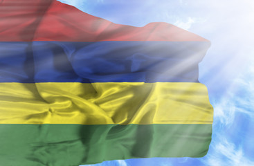 Mauritius waving flag against blue sky with sunrays