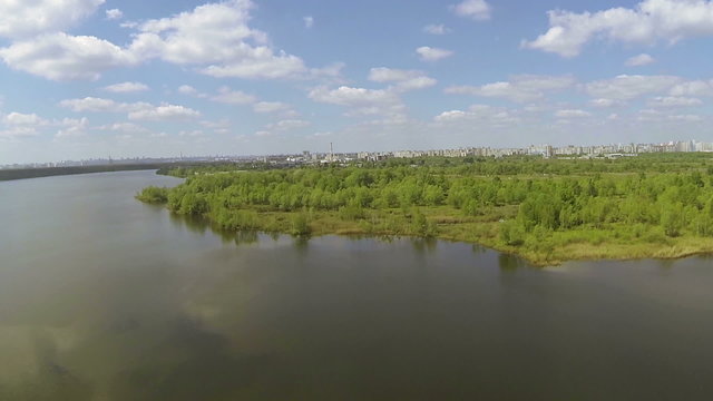 Wood and lake  with factory . Aerial slow movement