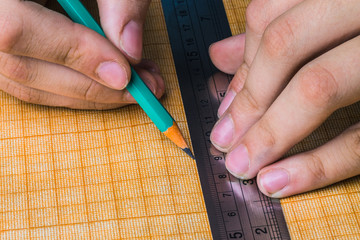 draftsman draws on a ruler