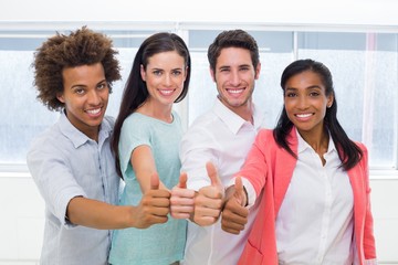 Group of workers giving thumbs up to camera