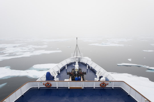 The view over the decks of a cruise ship in the Canadian Arctic region, moving through ice floes.