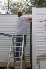 Worker repairing mobile home