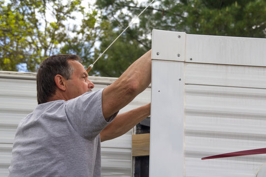 Worker Repairing Mobile Home