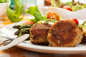 Meatballs served with boiled potatoes and asparagus