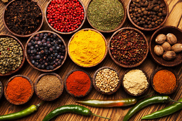 Spices and herbs in wooden bowls.