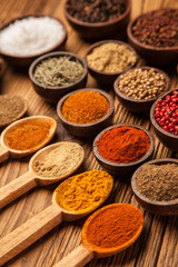 Spices and herbs in wooden bowls.