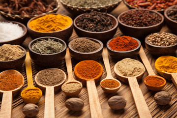 Spices and herbs in wooden bowls.