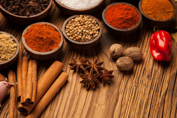 Spices and herbs in wooden bowls.