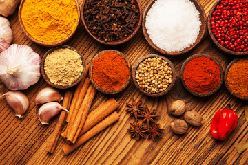 Spices and herbs in wooden bowls.